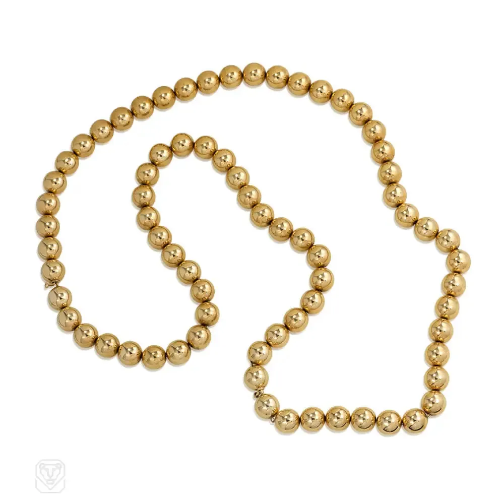 Gold bead necklace of adjustable length