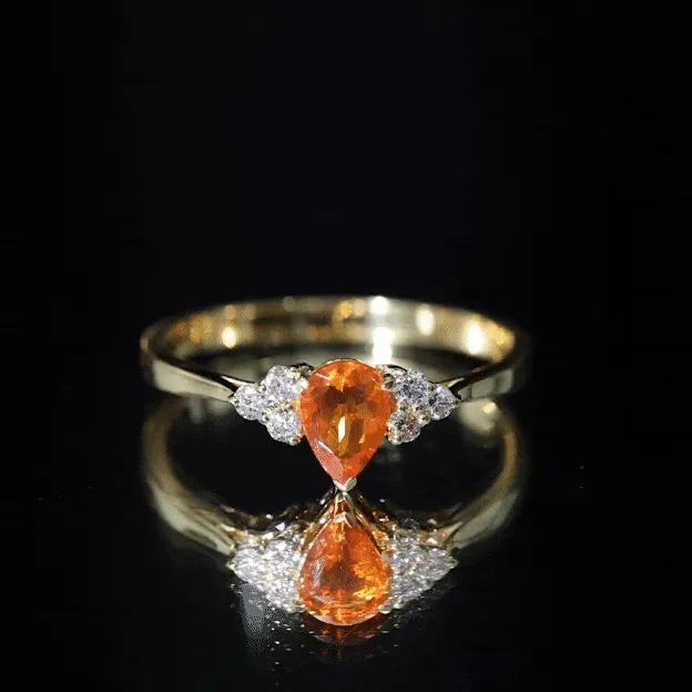 Pear Shaped Fire Opal Solitaire Ring with Diamond Trio