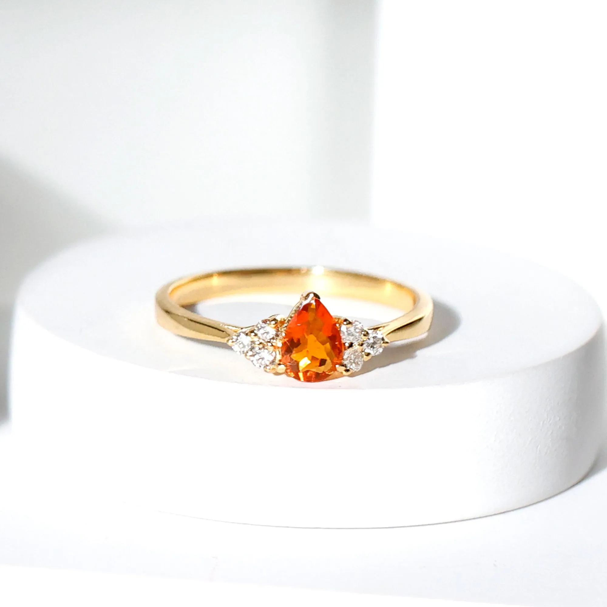 Pear Shaped Fire Opal Solitaire Ring with Diamond Trio